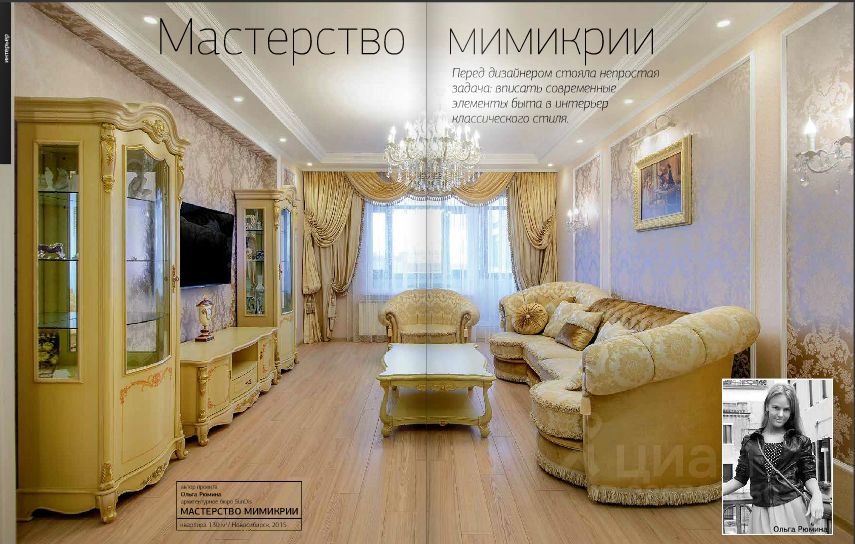 Интерьер оформлен в классическом стиле с современными элементами. Видна гостиная с мягкой мебелью светлых тонов, включая диван и кресла с изысканным текстилем. Стены украшены нежными пастельными оттенками и декоративными панелями. Центральная часть комнаты занимает изящный столик, окруженный уютной мебелью. Освещение обеспечивается стильной люстрой, создающей мягкий свет. В углу размещены витрины с декоративными предметами, а окна обрамлены тяжелыми шторами, придающими интерьеру элегантность. Пол выполнен из светлого дерева, что добавляет тепла и уюта в пространство.