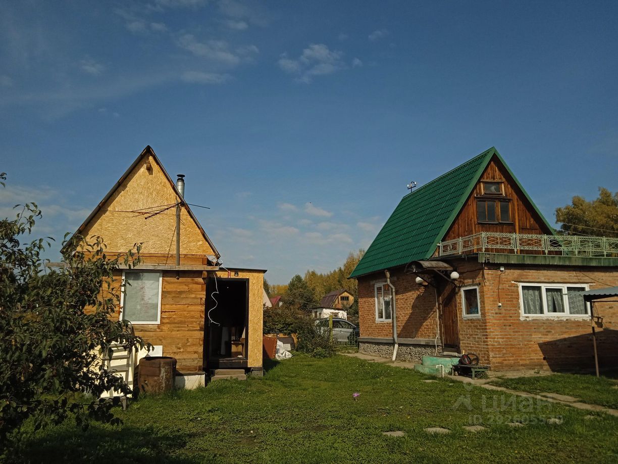 Два загородных дома с характерными архитектурными элементами. Первый дом имеет деревянную отделку и треугольную крышу, а также панорамное окно, что придаёт ему уютный вид. Второй дом выполнен из кирпича с зелёной крышей и балконом. Оба строения окружены зелёной травой, что создаёт приятную атмосферу. Используемые материалы включают дерево и кирпич, а цветовая гамма включает натуральные оттенки дерева и зелёный цвет крыши. Дома имеют простую, но функциональную планировку, подходящую для загородного проживания.
