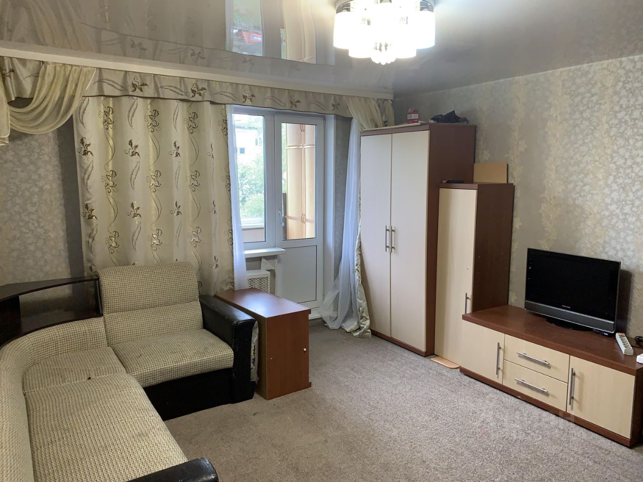 Светлая двухкомнатная квартира на 4 этаже в Екатеринбурге. Просторная гостиная с мебелью и выходом на балкон. Идеально для аренды.