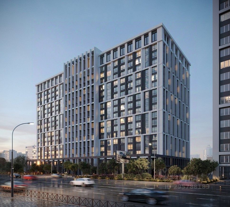 Современное здание в стиле минимализма с четкими геометрическими линиями и стеклянными фасадами. Структура включает восемь этажей, разделенных вертикальными панелями, создающими эффект ритма. Открытые балконы и большие окна обеспечивают естественное освещение. Цветовая палитра состоит из светлых и темных оттенков, что придает зданию элегантный вид. Использование стекла и бетона подчеркивает современный подход к архитектуре. В нижней части здания расположены зеленые насаждения, что создает гармоничное сочетание с городской средой.